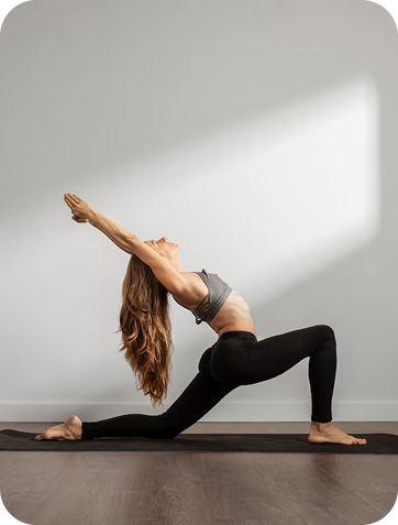 У кімнаті жінка з довгим волоссям займається йогою, виконуючи складну позу.